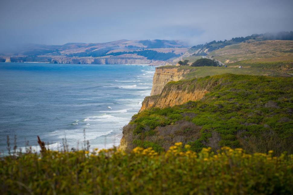 Free Image of Coastal cliffs with waves and cloudy sky 