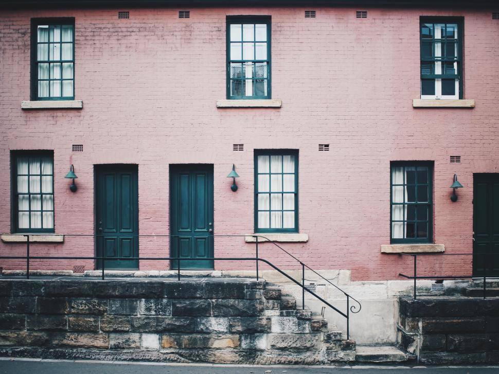 Free Image of Symmetrical view of pink brick building 