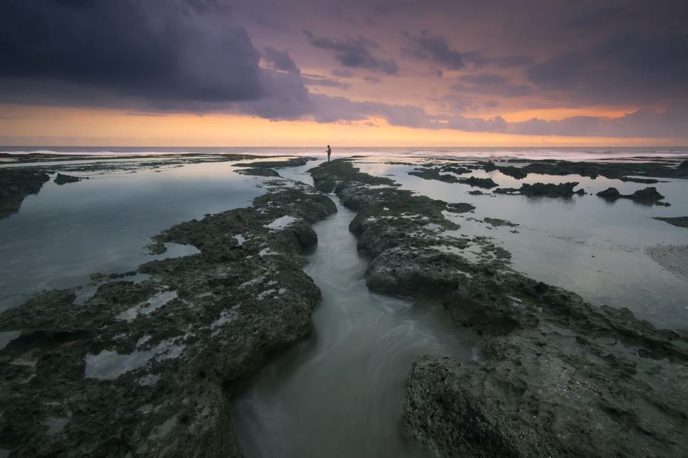 Free Image of Moody tidal pools with dramatic sky at twilight 