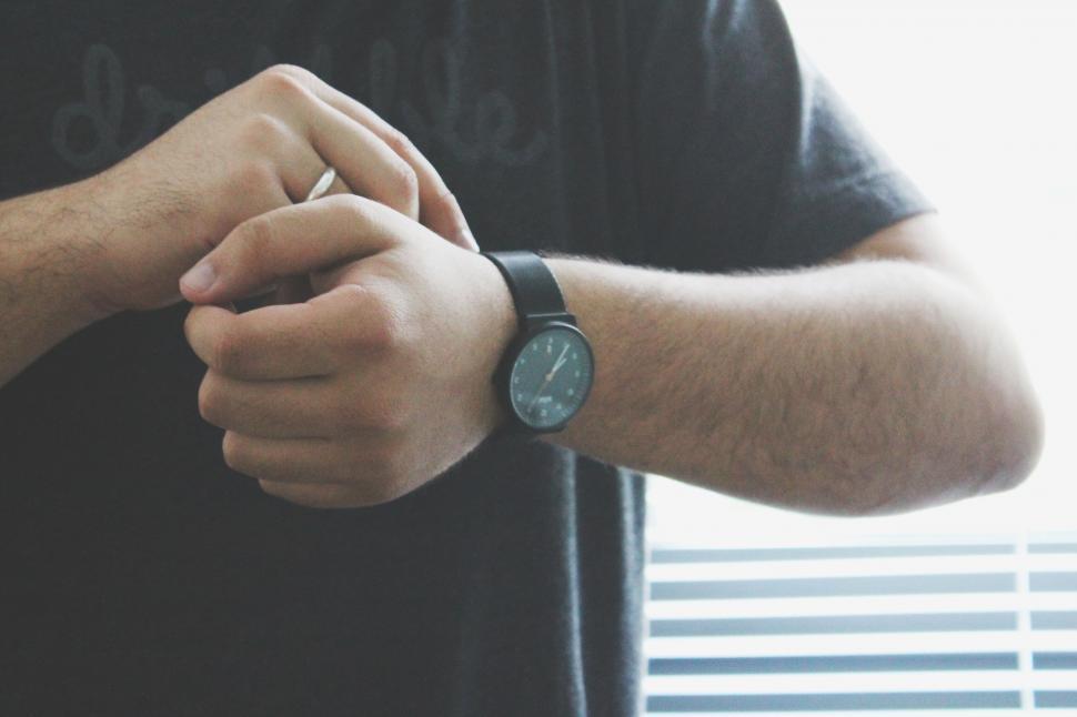 Free Image of Person checking the time on wristwatch 