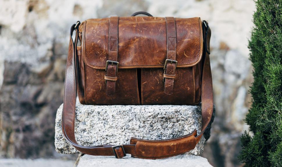 Free Image of Leather backpack on a stone ledge 