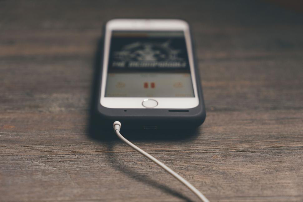 Free Image of Smartphone with earphones and music app 