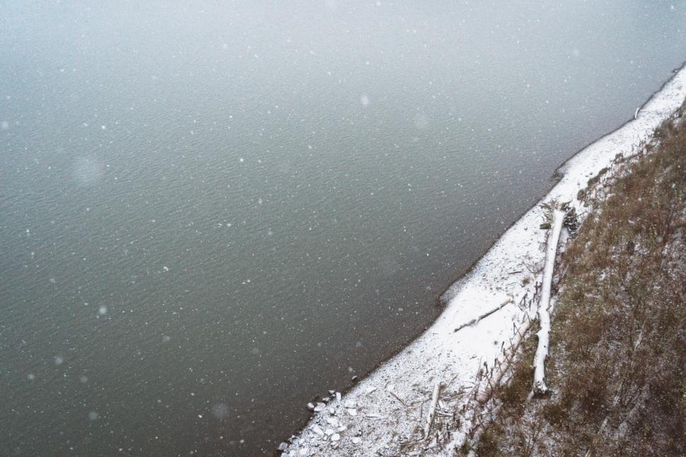 Free Image of Snowy shoreline on a gray winter day 