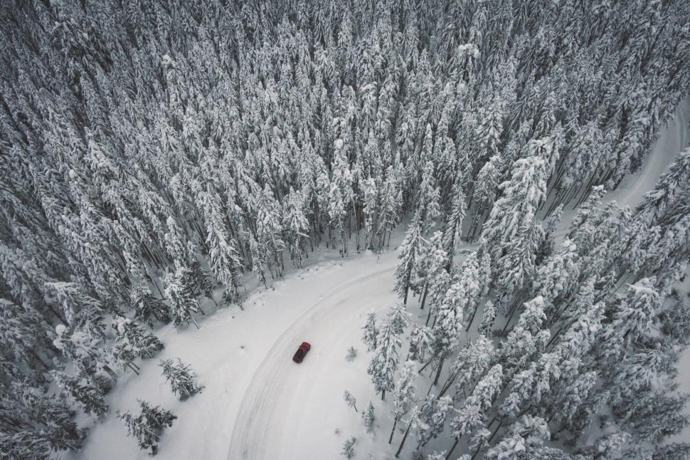 Free Image of Aerial view of red car on snowy road 