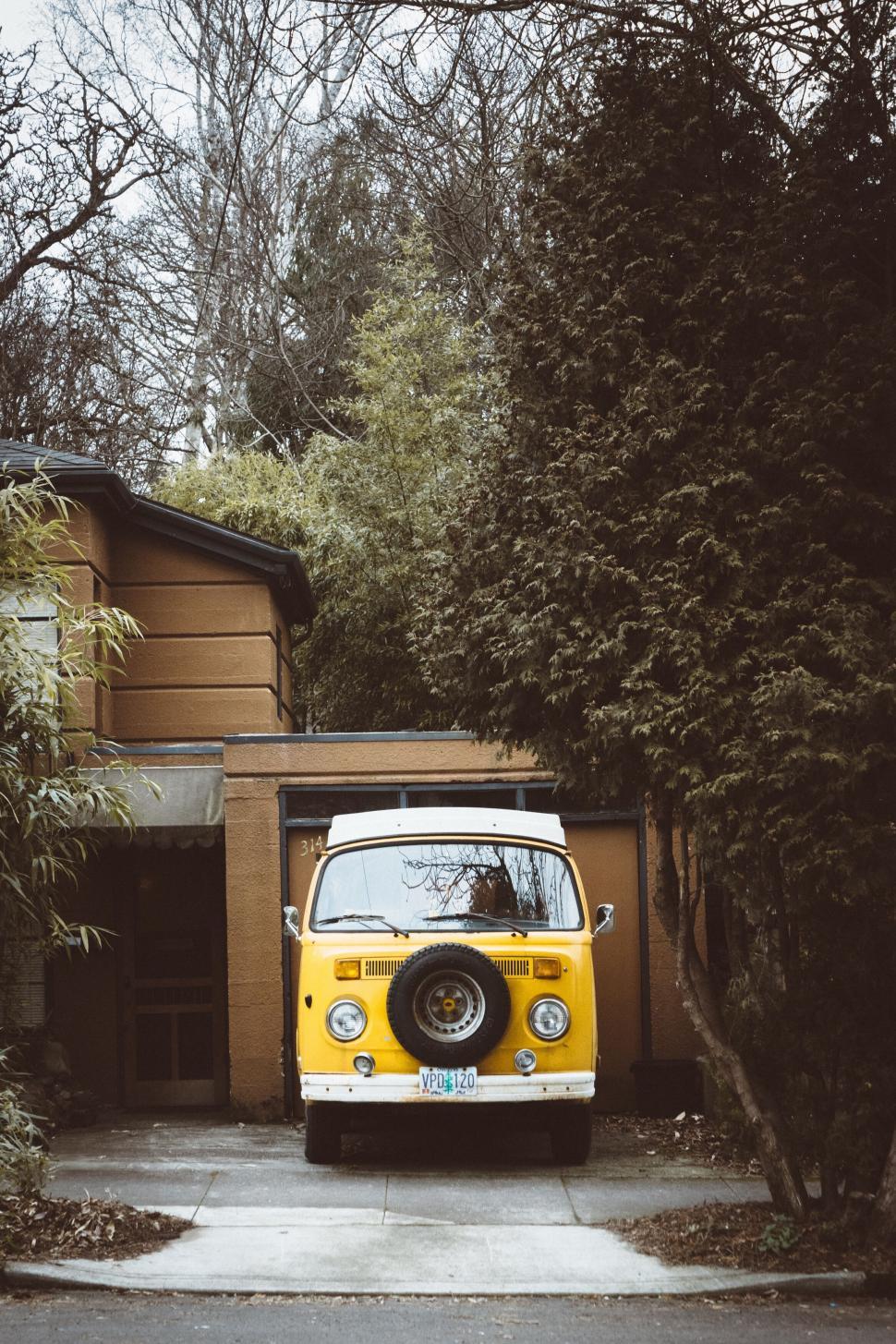 Free Image of Retro yellow van parked in front of house 