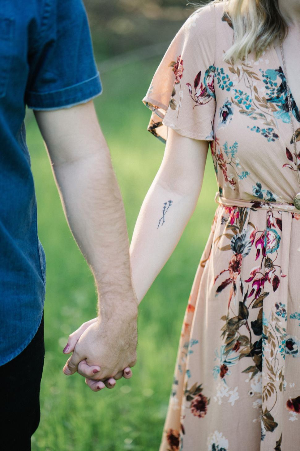 Free Image of Couple holding hands, intimate moment 