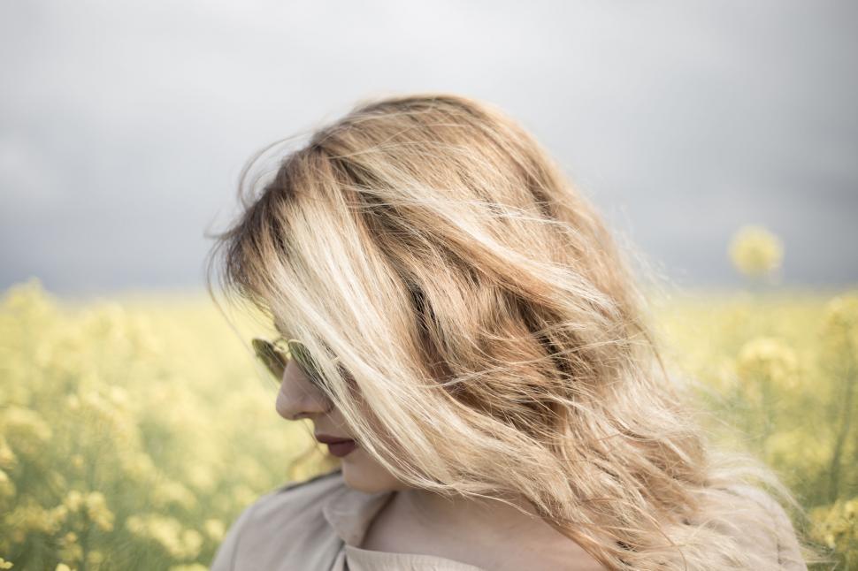 Free Image of Blurred face of person in a field of flowers 