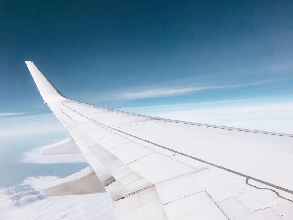 Free Image of View from airplane window on wing and clouds 