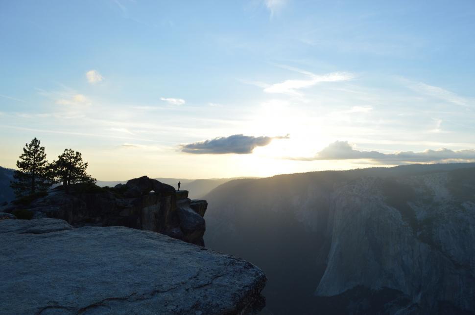 Free Image of Sunset over mountain landscape with person 