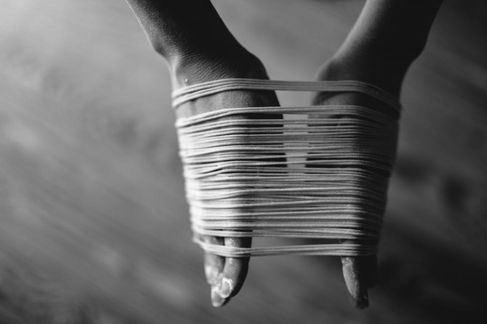 Free Image of Black and white photo of bound hands 