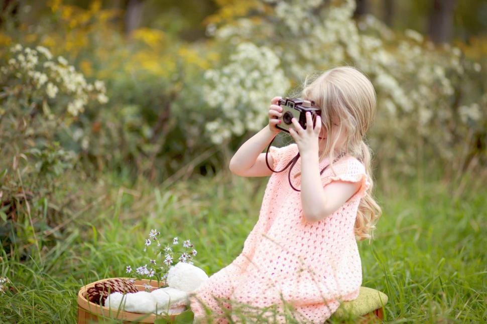 Free Image of Young girl taking photo with vintage camera 