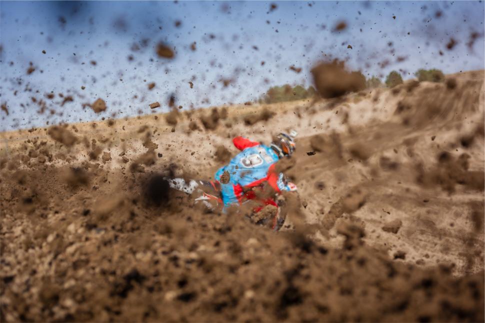 Free Image of Motocross rider caught in mud splash 