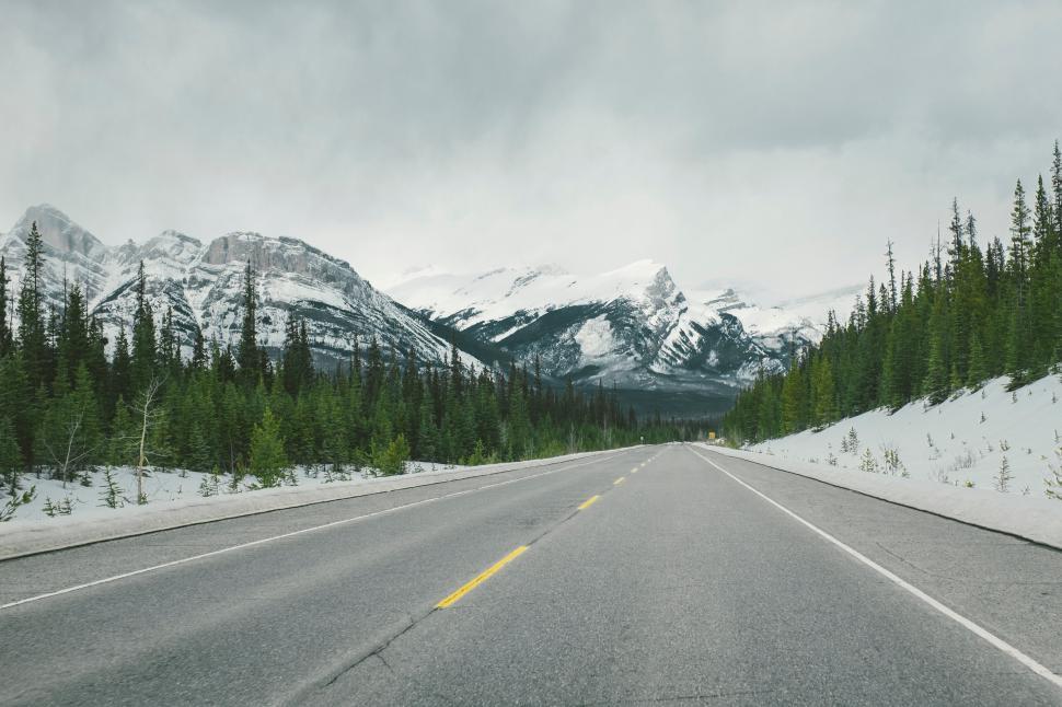 Free Image of Mountain road with snow-capped peaks 
