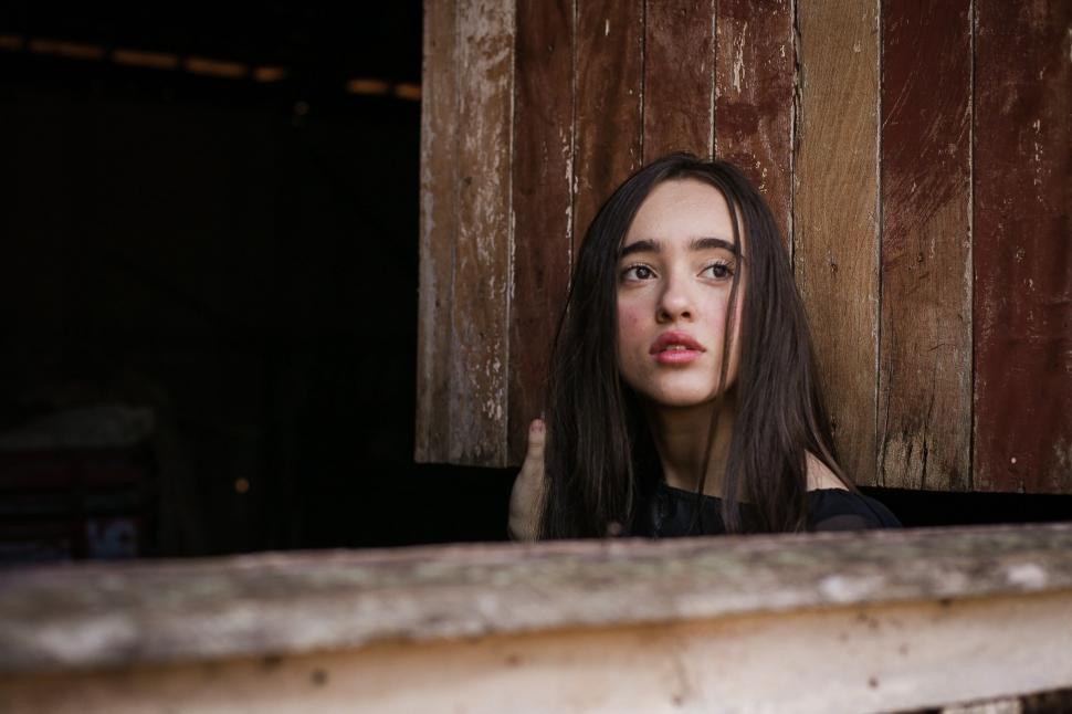 Free Image of Person peering over wooden ledge 
