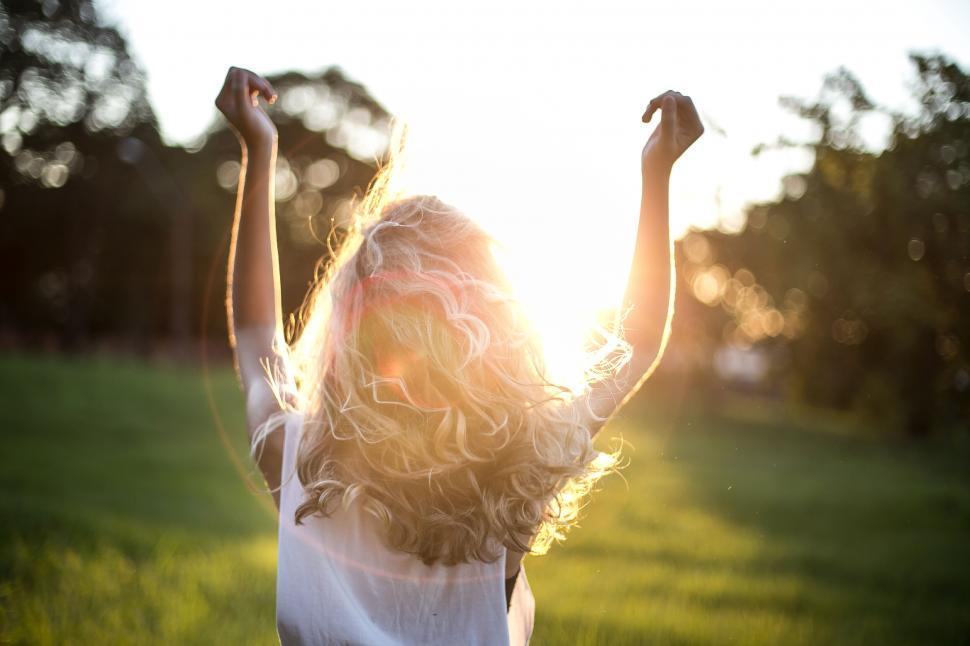 Free Image of Girl celebrating in evening sunlight 