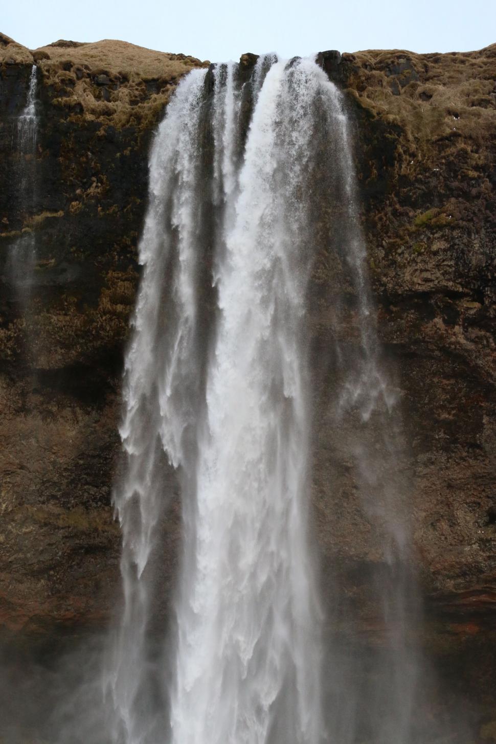 Free Image of Majestic waterfall cascading down cliffs 