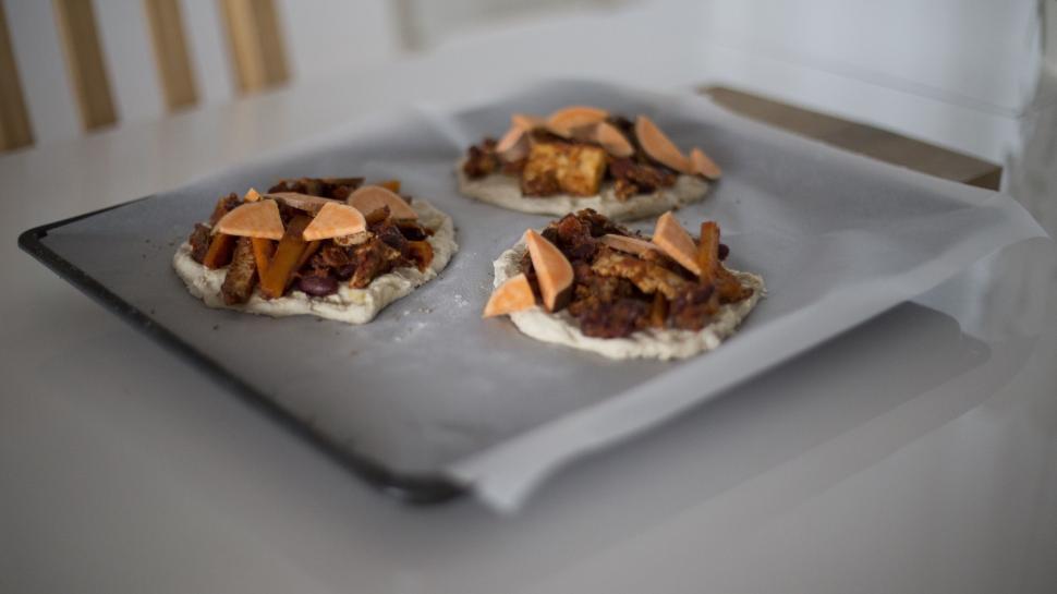 Free Image of Uncooked pizzas on baking tray in kitchen 