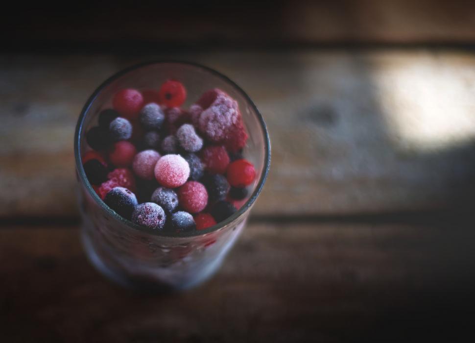Free Image of Glass of frozen mixed berries on table 