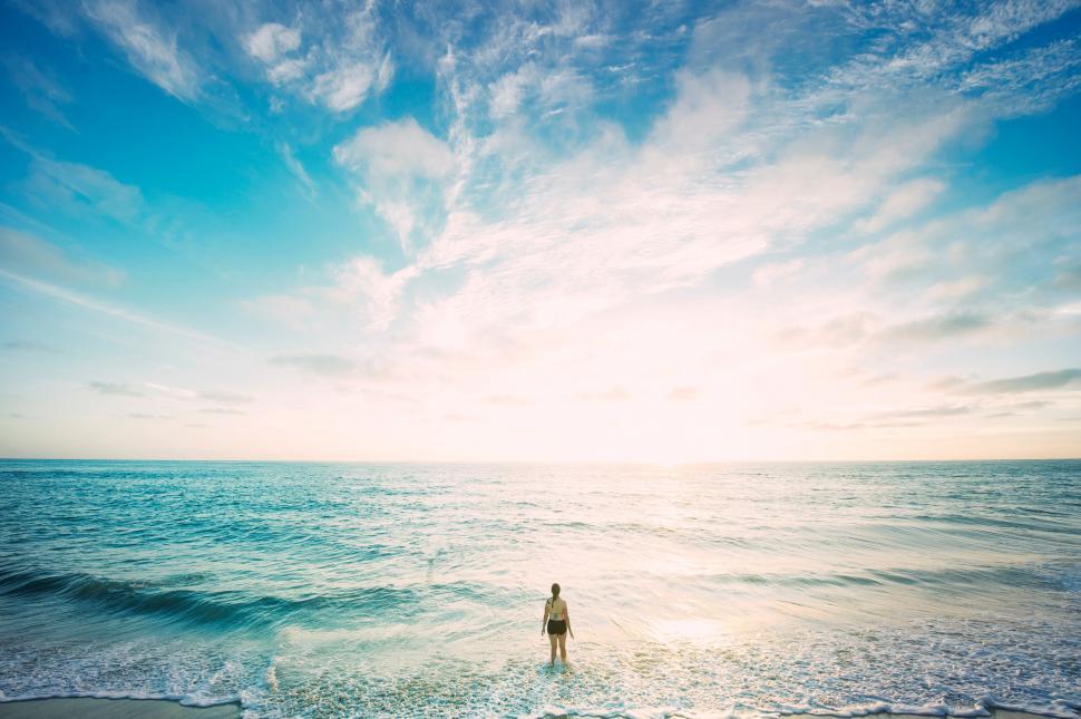 Free Image of Person standing on beach during sunset 