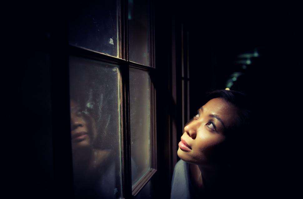 Free Image of Mysterious figure by foggy window 