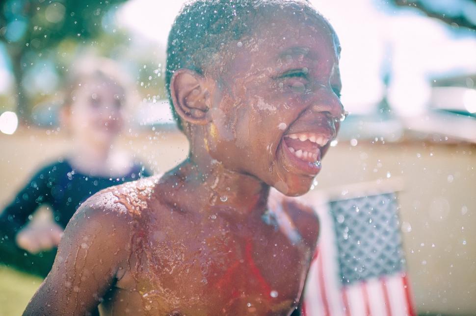 Free Image of Children playing with water outdoors 