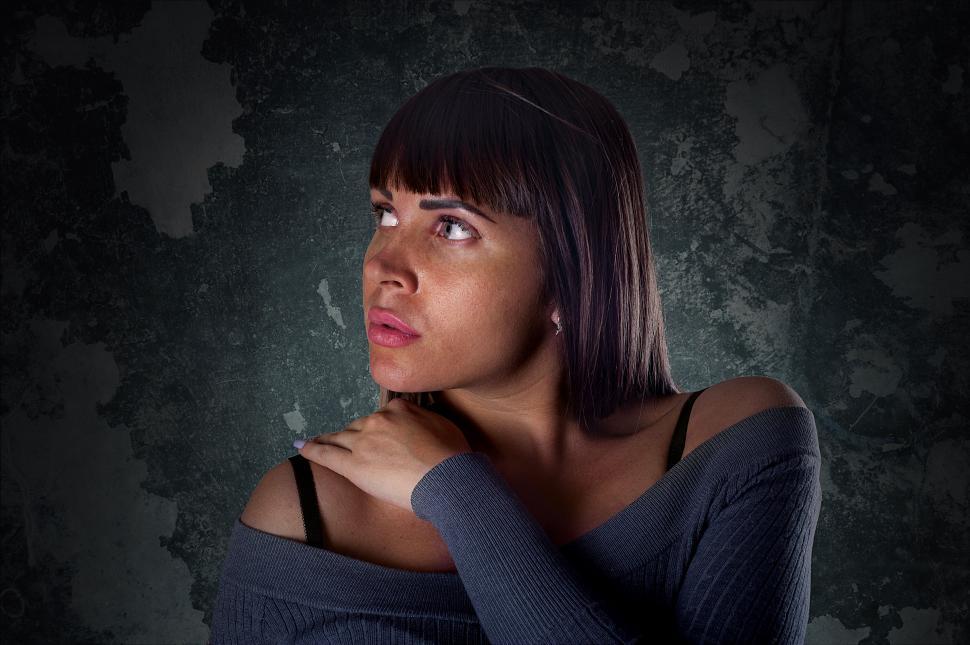 Free Image of Woman with crossed arms in a dark room 