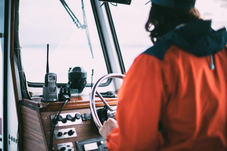 Free Image of Person steering a boat with navigation equipment 
