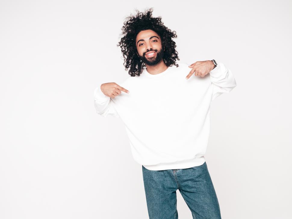 Free Image of A man pointing at his shirt 
