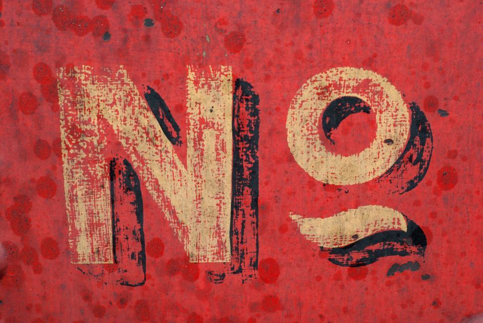 Free Image of Weathered  NO  Sign on Rusty Red Background 