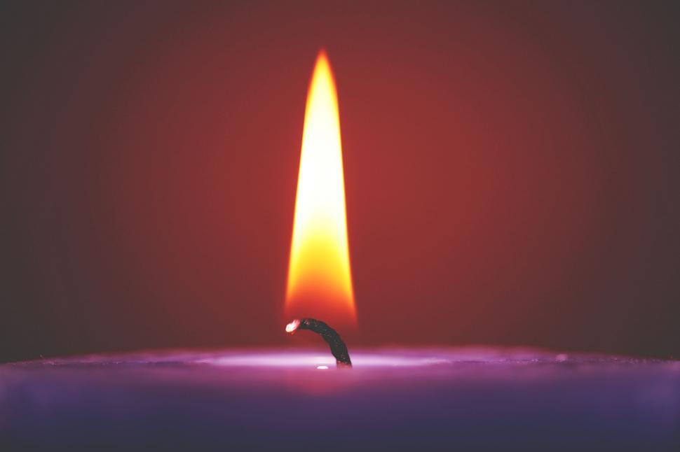 Free Image of Candle flame close up on dark background 