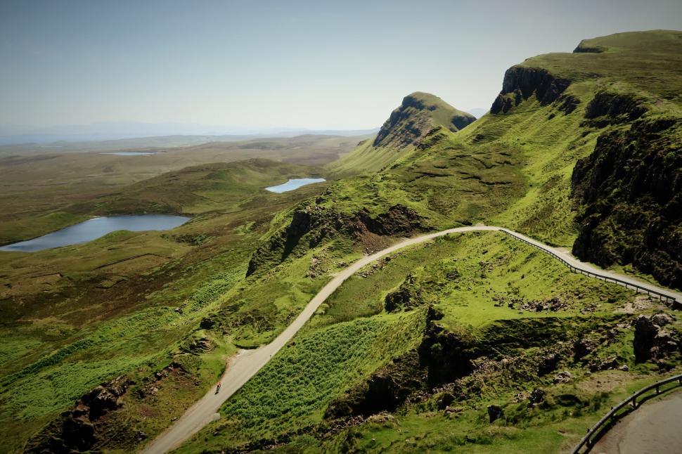 Free Image of Scenic hillside road winding in countryside 