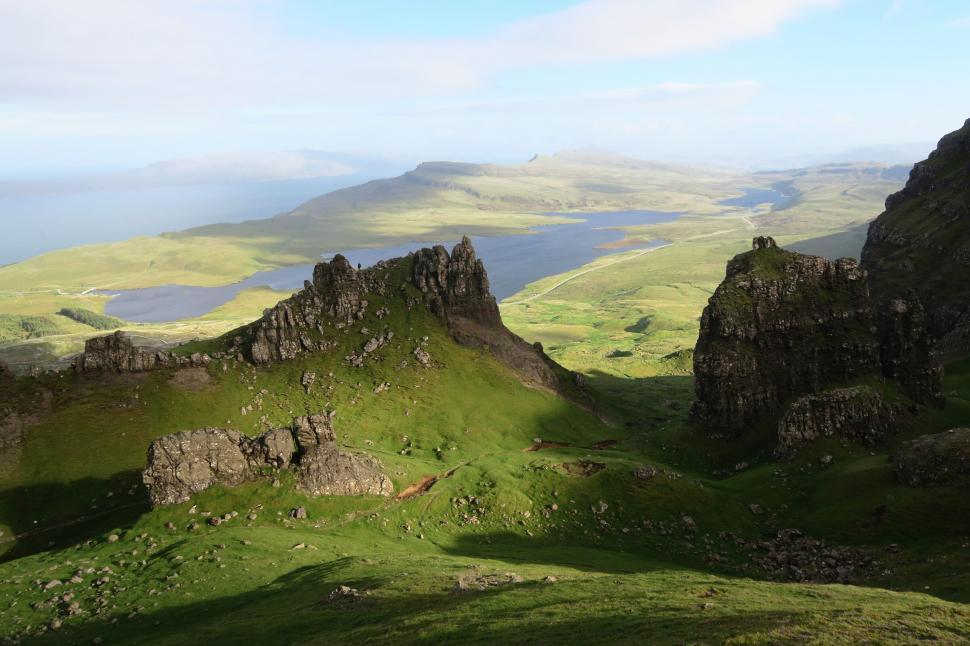 Free Image of Green hill landscape with rock formations 