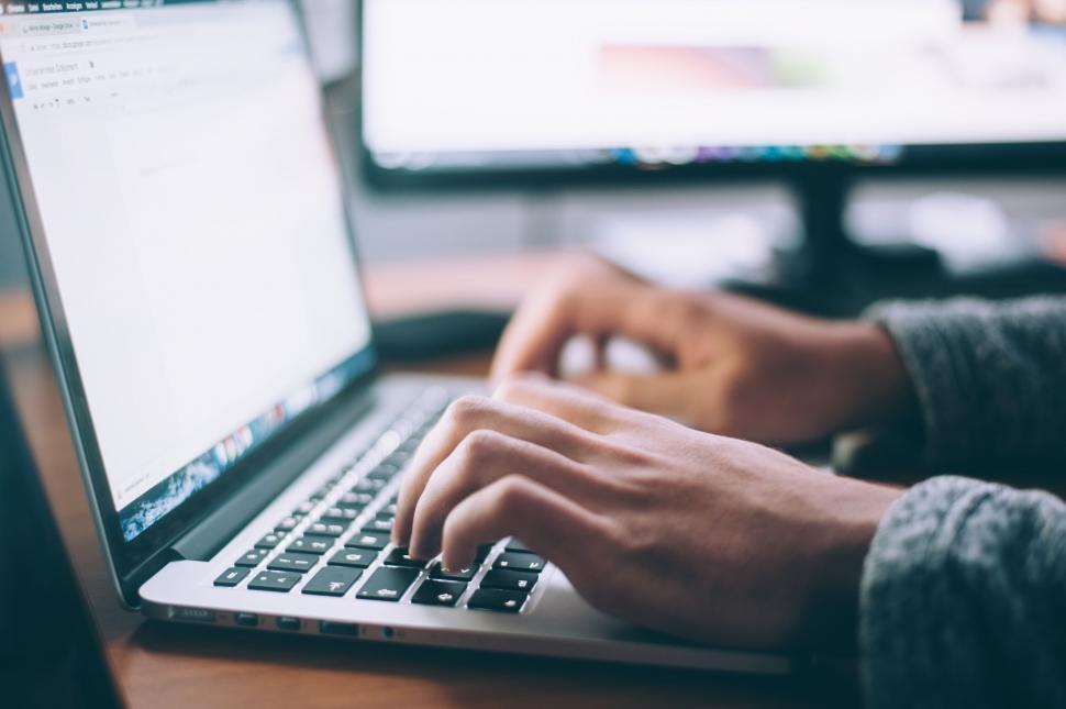 Free Image of Close up of hands typing on a laptop keyboard 