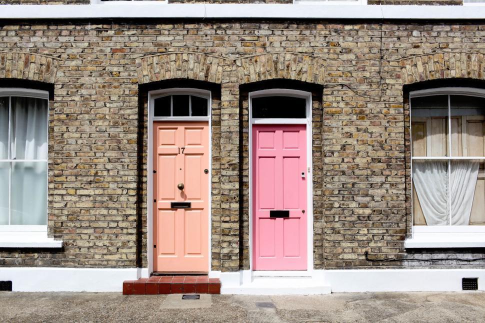 Free Image of Colorful doors on a brick townhouse 