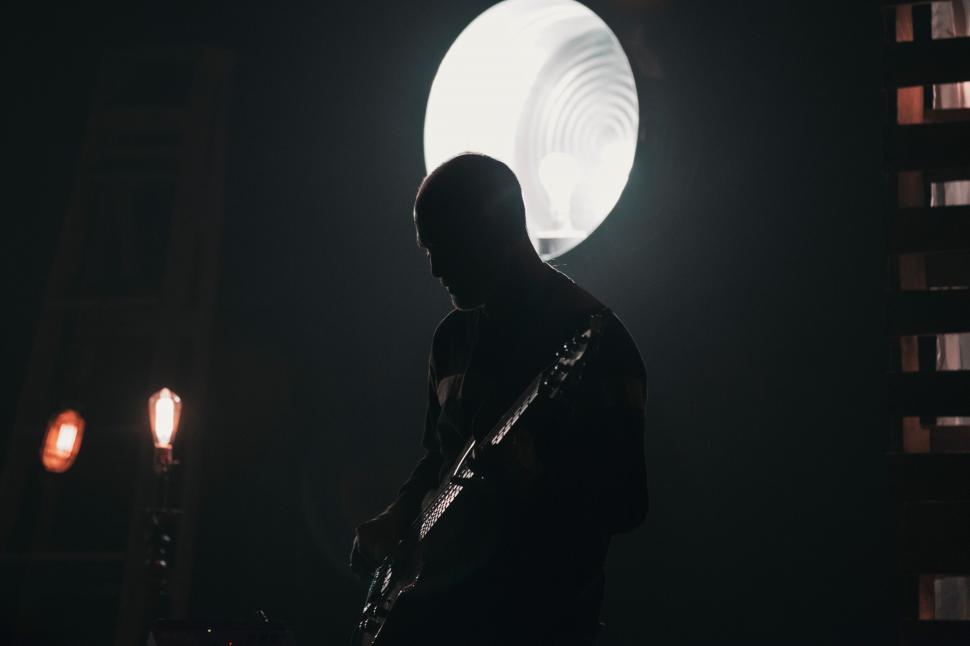 Free Image of Silhouetted Musician Against Bright Moon 