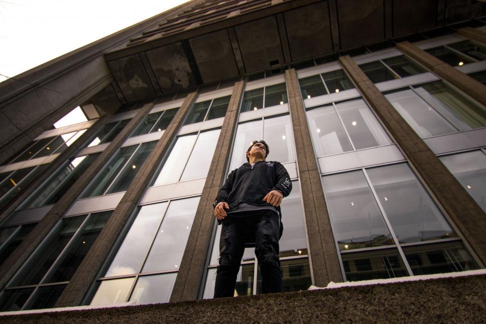 Free Image of Person standing in front of modern building 