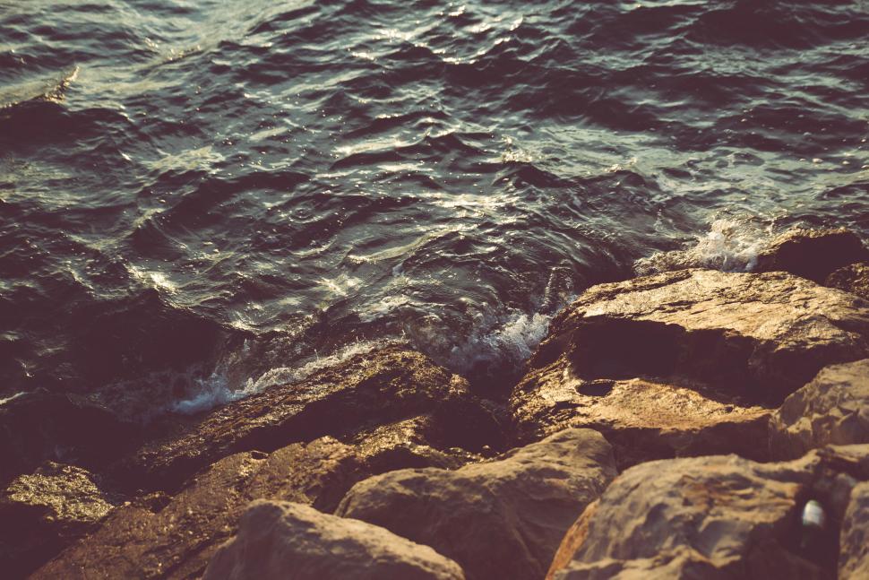 Free Image of Sunset light over rocky seaside shore 