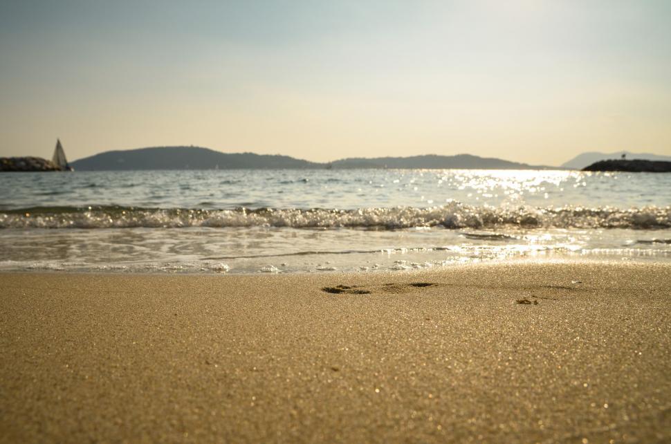 Free Image of Beach view with sparkling sea at sunset 