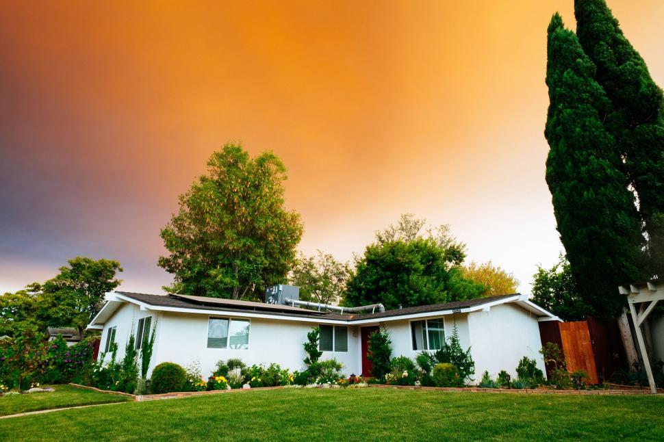 Free Image of Suburban home under dramatic sunset sky 