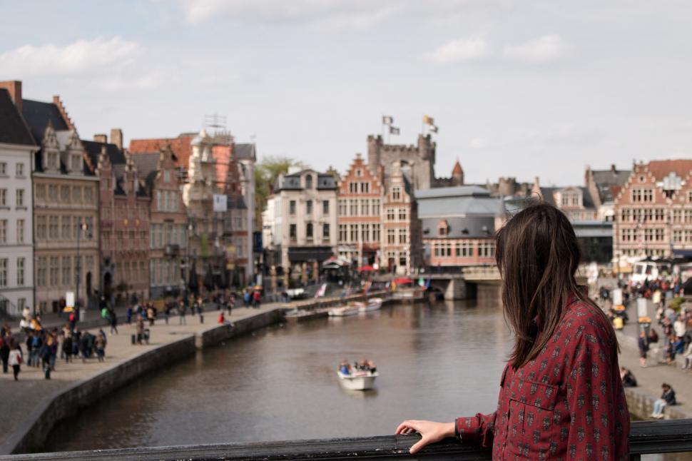 Free Image of Woman overlooking city riverfront 