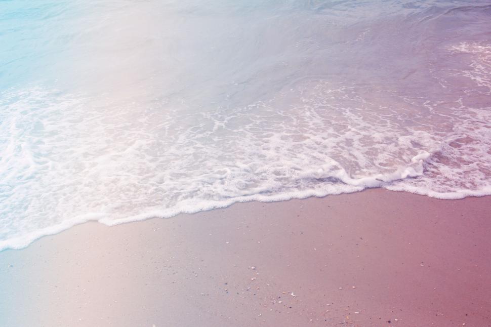 Free Image of Gentle sea wave on pink sandy beach 