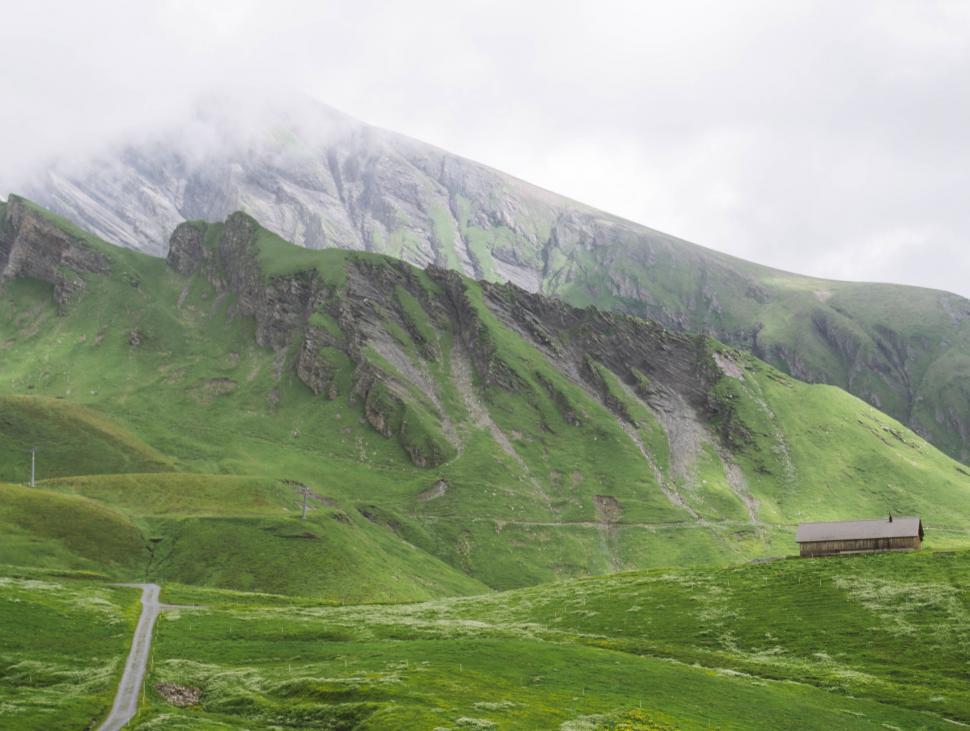 Free Image of Misty mountain landscape with a small cabin 