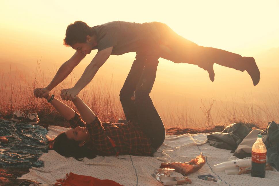 Free Image of Couple doing acroyoga at sunset 