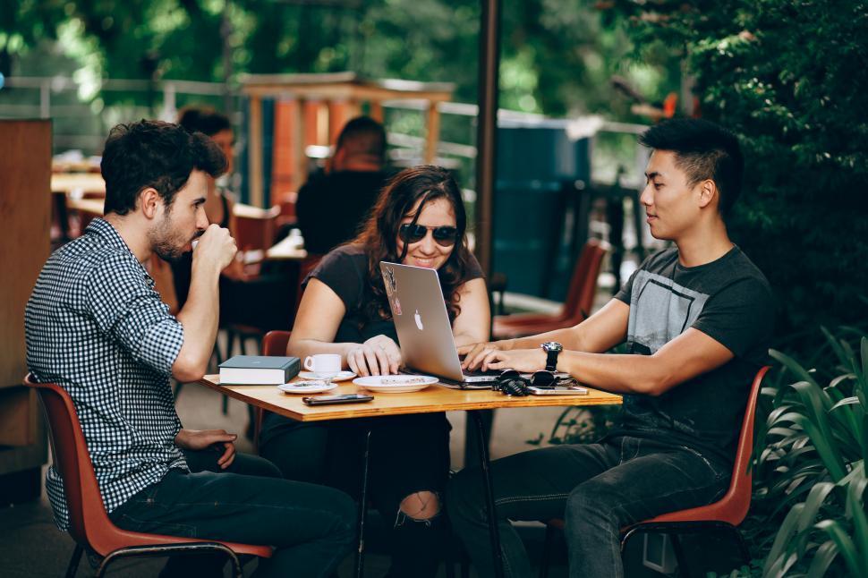 Free Image of Group of friends working on a project outdoors 