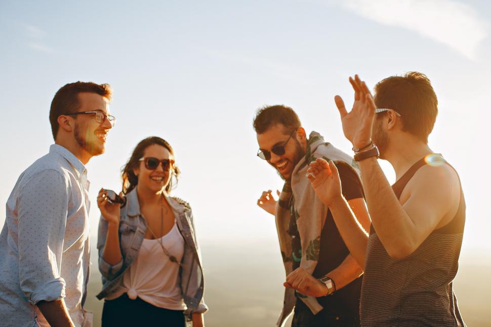 Free Image of Friends enjoying a conversation at sunset 