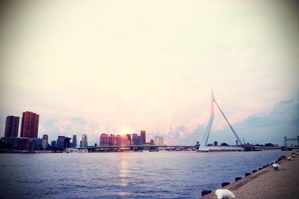 Free Image of Sunset over a cityscape with a bridge 