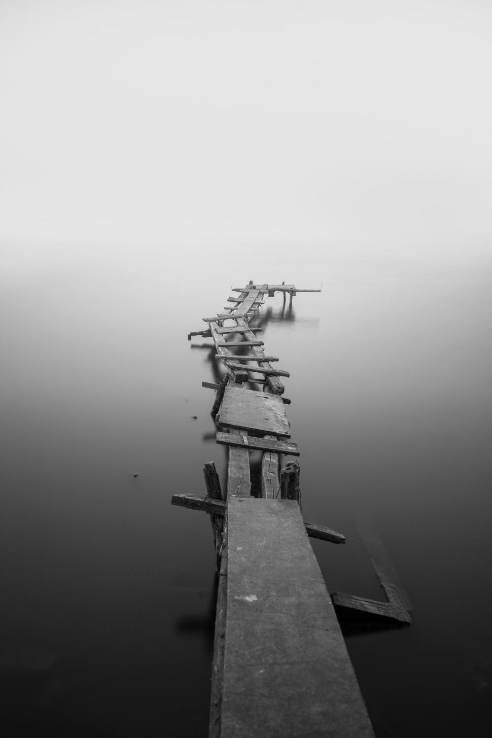 Free Image of Black and white image of a foggy pier 