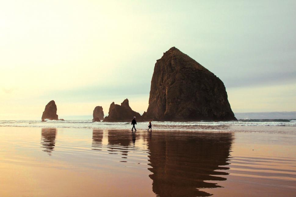 Free Image of Silhouette of people by a monolithic rock 