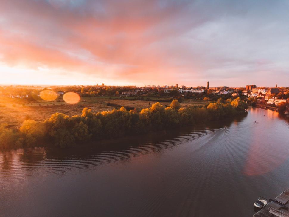 Free Image of Sunset over a river and cityscape 