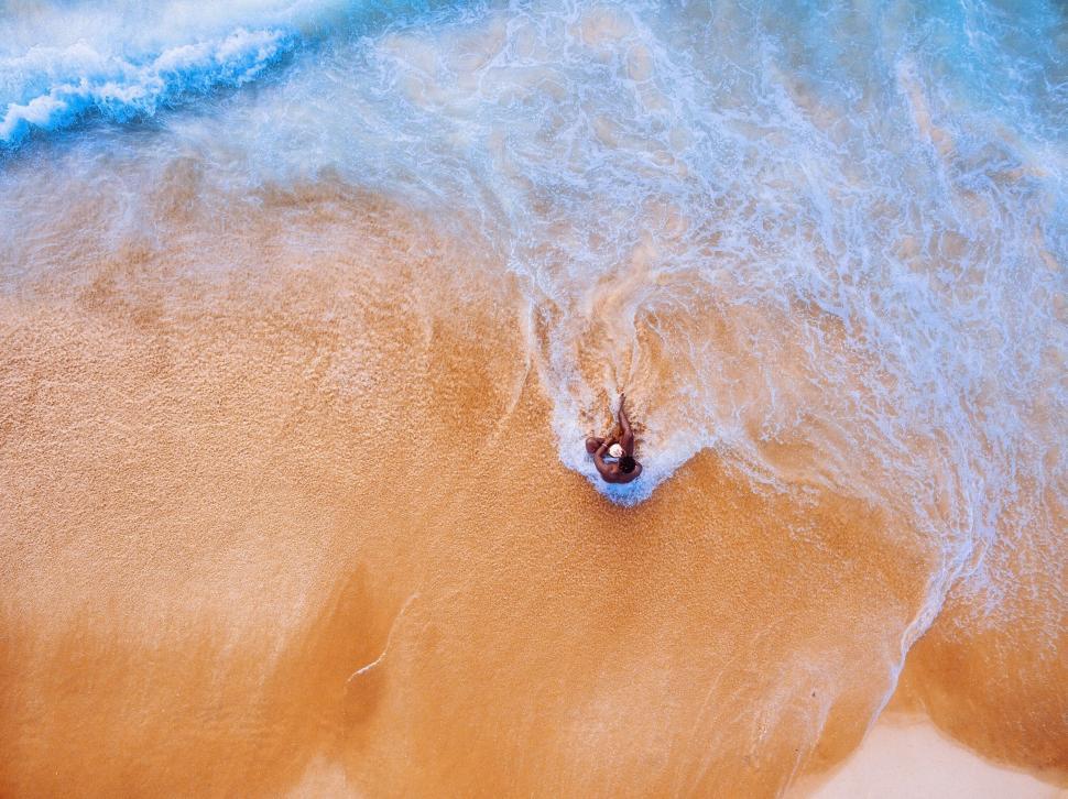 Free Image of Aerial view of a person in ocean waves 